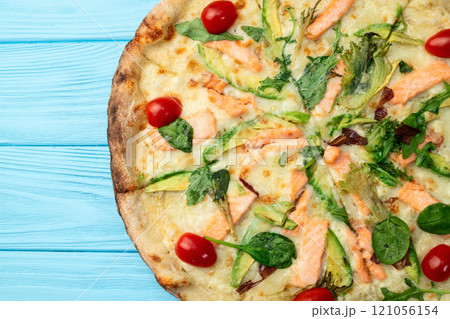 Italian pizza with avocado salmon tomatoes and mozzarella photography. top view Italian pizza with avocado salmon tomatoes and mozzarella photography. top view 121056154
