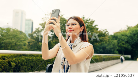 Woman, travel and selfie with confident in city, memory and photography for post with app in nature. Person, smile and profile picture with inspiration, reflection and outdoor at park in Japan 121056537
