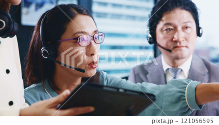 Call center, headset and Japanese woman in team, customer service or technical support for training. Female person, microphone and telecommunication in consulting, coworking or coaching for help desk 121056595