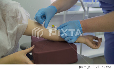 The doctor injects the patient into a vein. Close up - blood test from a vein of the arm. Intravenous anesthesia. The doctor injects the patient into a vein. Close up - blood test from a vein of the arm. Intravenous anesthesia. 121057368