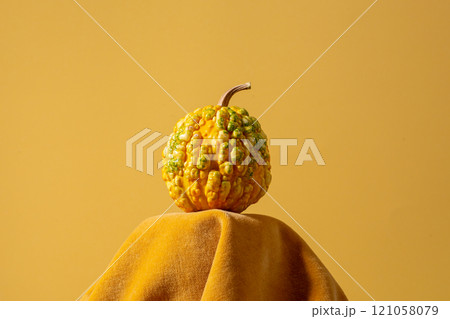 Pumpkin on a yellow background , creative concept . View with copy space 121058079