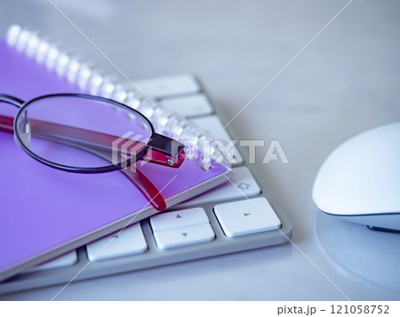 テーブルに置かれた手帳とキーボードとメガネ テーブルに置かれた手帳とキーボードとメガネ 121058752