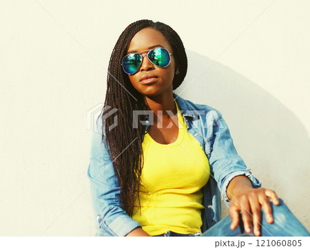 Fashion portrait of african woman in sunglasses over white background 121060805