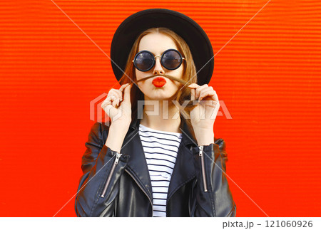 Fashion portrait funny young woman shows mustache hair blowing red lips kiss having fun 121060926