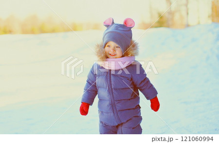 Winter portrait funny smiling child walking in snowy day 121060994