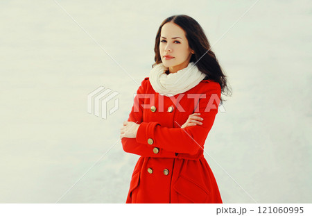 Fashion beautiful young woman wearing a red jacket in winter day 121060995