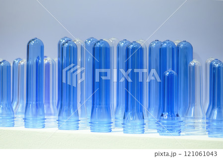 Close up scene of group of preform shape of PET bottle products. 121061043