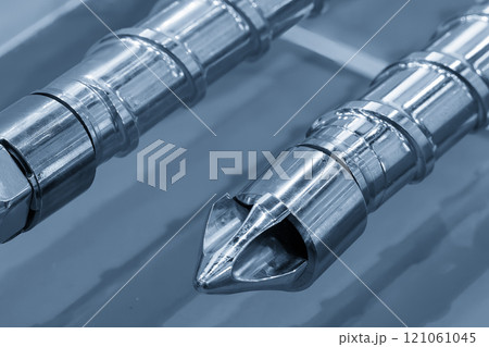 Close up scene the head of barrel screw of injection machine spare parts in the light blue scene. 121061045