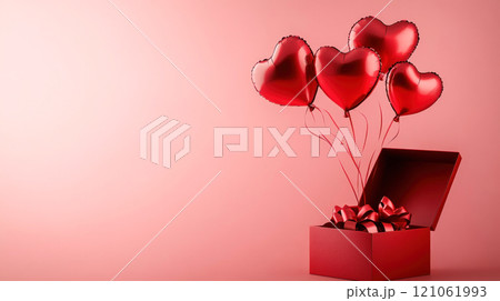 Red heart shaped balloons fly out of gift box. Valentine's Day concept Red heart shaped balloons fly out of gift box. Valentine's Day concept 121061993