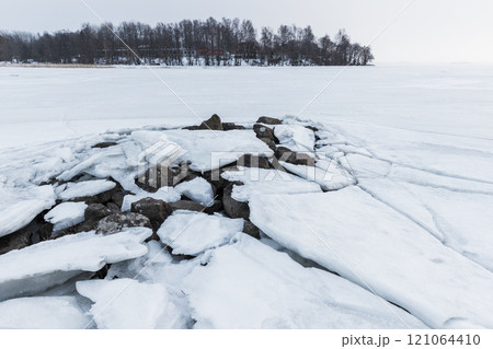 Landscape with frozen Baltic sea coast. Cracked ice, winter day 121064410