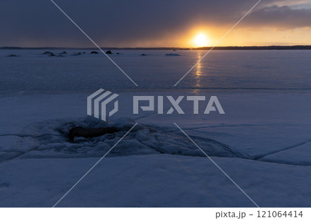 Winter landscape with frozen Baltic sea at sunset 121064414