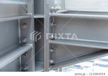 Gray metal girders connected with bolts, close-up photo Gray metal girders connected with bolts, close-up photo 121064454