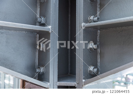 Corner of gray metal structures connected with bolts Corner of gray metal structures connected with bolts 121064455
