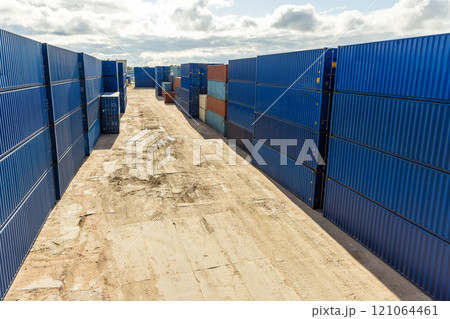 Cargo containers are stacked at the storage area on a sunny day 121064461