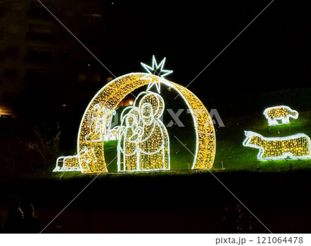 Christmas. Light. Christmas lights through the streets of Madrid. Decorating streets of the city. Fir tree with Christmas lights. Christmas ball. On. MADRID. SPAIN. 11 December 2024. 121064478