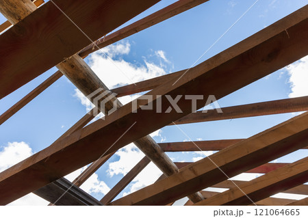 Unfinished roof of a log house under construction 121064665