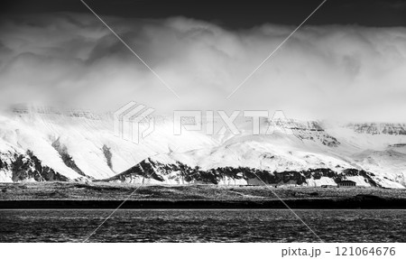 Coastal Icelandic landscape with snowy mountains 121064676