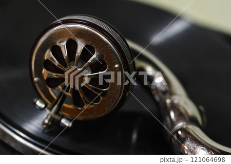 Needle of an old phonograph and black vinyl record, close up photo Needle of an old phonograph and black vinyl record, close up photo 121064698