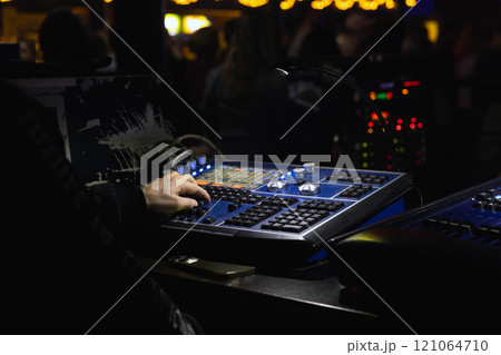 Sound engineer works at a mixing console, close-up 121064710