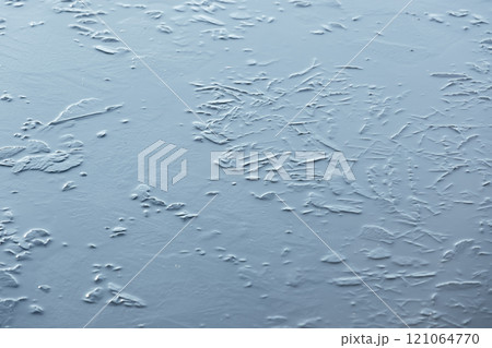 Thin ice layer on a frozen lake, natural winter background photo 121064770