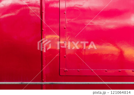 Shiny red hull with rivets, background texture 121064814