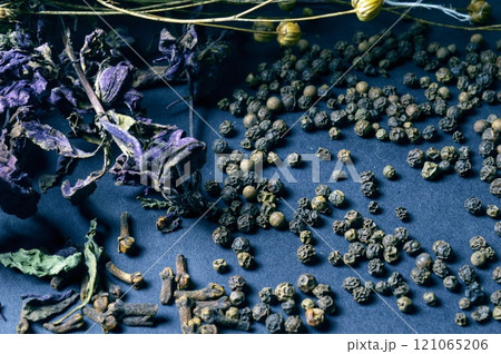 various spices scattered on a dark background with bunches of grass, laurel leaves, berries and other spices for cooking fragrant Eastern and Midwestern food. High quality photo various spices scattered on a dark background with bunches of grass, laurel leaves, berries and other spices for cooking fragrant Eastern and Midwestern food. High quality photo 121065206