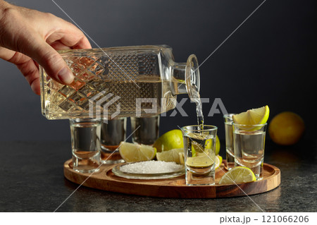 Gold tequila with salt and lime slices. 121066206