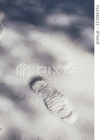 A footprint on virgin snow in sunshine and shadows A footprint on virgin snow in sunshine and shadows 121066352