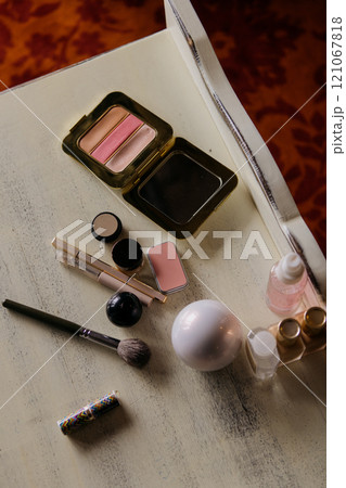 There is a table that is covered with an array of makeup products There is a table that is covered with an array of makeup products 121067818
