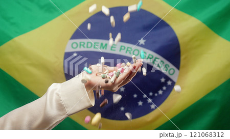 Pills Falling On Female Hand On Brazilian Flag Background. Expensive Medication 121068312