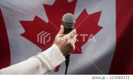 Woman Singer Tv Presenter Holding Mic, Mike Or Microphone In Hand On Canadian Woman Singer Tv Presenter Holding Mic, Mike Or Microphone In Hand On Canadian 121068315