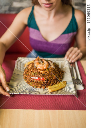 Chaulafan marisco ecuatoriano, Gastronomy. Typical dinner dish close-up. Unrecognizable woman hand Chaulafan marisco ecuatoriano, Gastronomy. Typical dinner dish close-up. Unrecognizable woman hand 121069318
