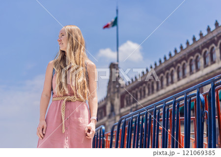 Female tourist in the central square of Mexico City, Zocalo. Cultural exploration, travel, and historic architecture concept 121069385