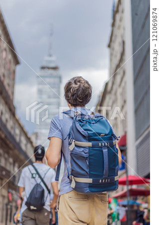 Male tourist exploring Latin American Tower in Mexico City. Iconic skyscraper, historic architecture, and urban exploration concept Male tourist exploring Latin American Tower in Mexico City. Iconic skyscraper, historic architecture, and urban exploration concept 121069874