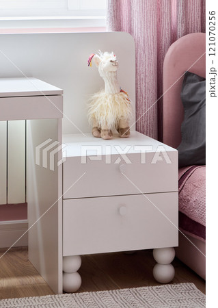 Charming and Elegant White Nightstand Perfectly Complemented by a Decorative Toy for Kids 121070256