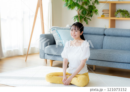 リビングでくつろぐ若い女性 121073152