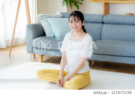 リビングでくつろぐ若い女性 リビングでくつろぐ若い女性 121073156