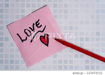 The word love written on a post-it or note. 121073532