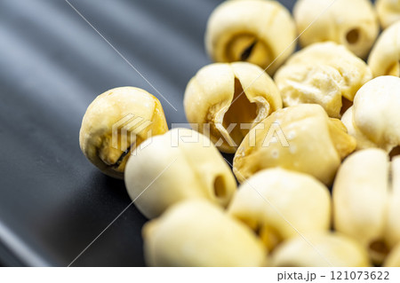 Closeup view of lotus seeds (Nelumbo nucifera) in the bowl Closeup view of lotus seeds (Nelumbo nucifera) in the bowl 121073622
