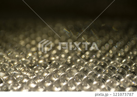 White water gel balls. Polymer gel. Silica gel. Balls of hydrogel round shape. Crystal liquid ball with reflection. Water beads 121073787