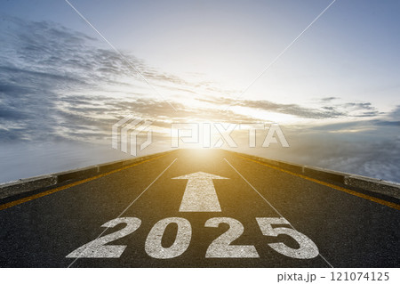 2025 number written on asphalt road with arrow to ahead symbol on blue sky background 2025 number written on asphalt road with arrow to ahead symbol on blue sky background 121074125