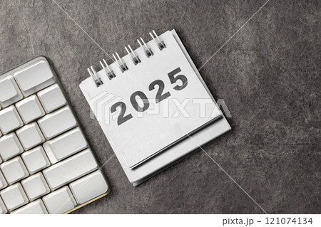 Calendar or Notepad with the number 2025 on a black background 121074134