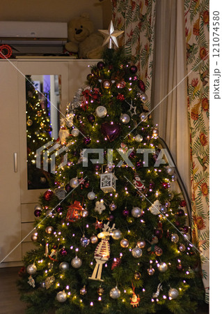 Close up Christmas tree with awesome toys in a cozy living room Close up Christmas tree with awesome toys in a cozy living room 121074580