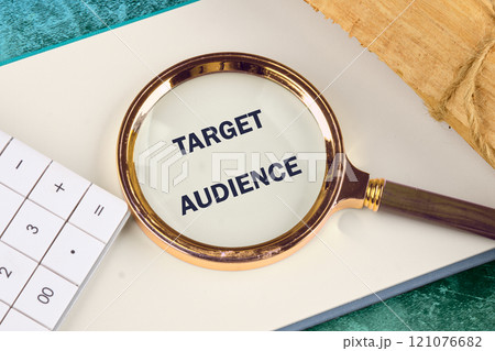 Target audience. marketing concept. the concept of finding customers. TARGET AUDIENCE written in a notebook, detected with a magnifying glass 121076682