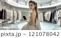 Beautiful young model is shopping in a large department store. 121078042
