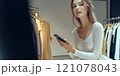 Beautiful young model is shopping in a large department store. 121078043