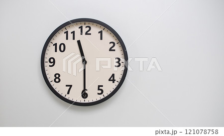 Classic Black-Edged Clock on White Background at 23.30/11.30 - Perfect for Time Management and Text Space 121078758
