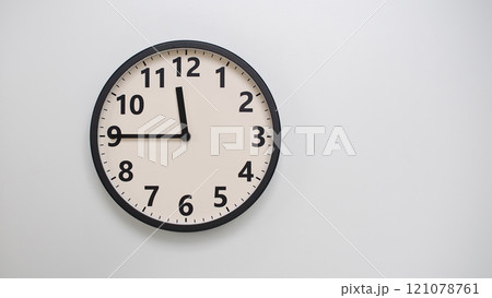 Classic Black-Edged Clock on White Background at 23.45/11.45 - Perfect for Time Management and Text Space 121078761