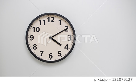 Classic Black-Edged Clock on White Background at 16.10/04.10 - Perfect for Time Management and Text Space 121079127
