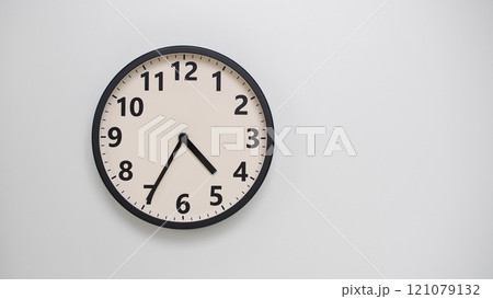 Classic Black-Edged Clock on White Background at 16.35/04.35 - Perfect for Time Management and Text Space 121079132